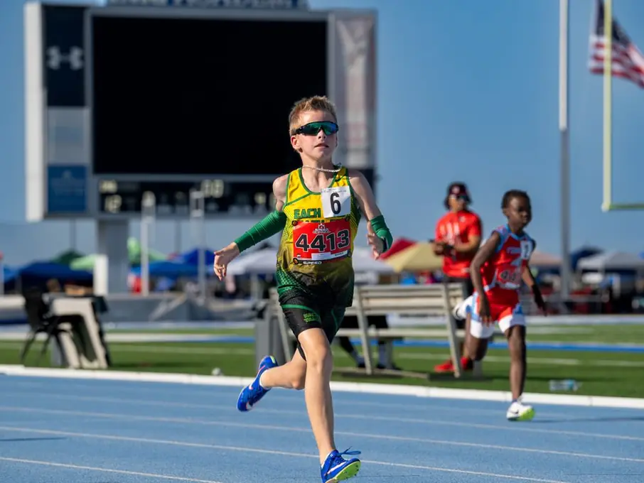 Young sprinter charging down the track