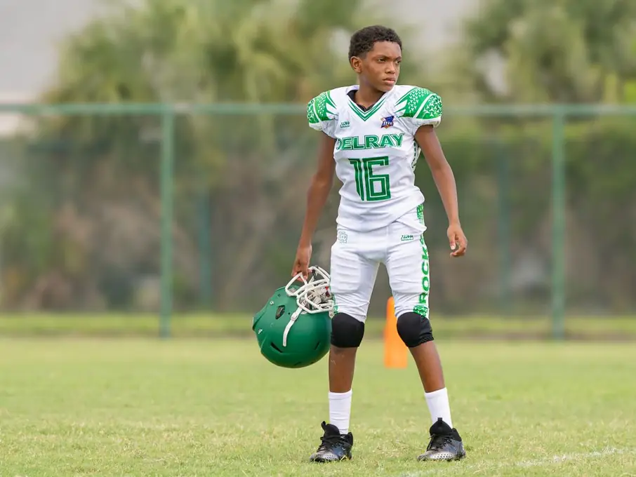 Delray football player holding his helmet