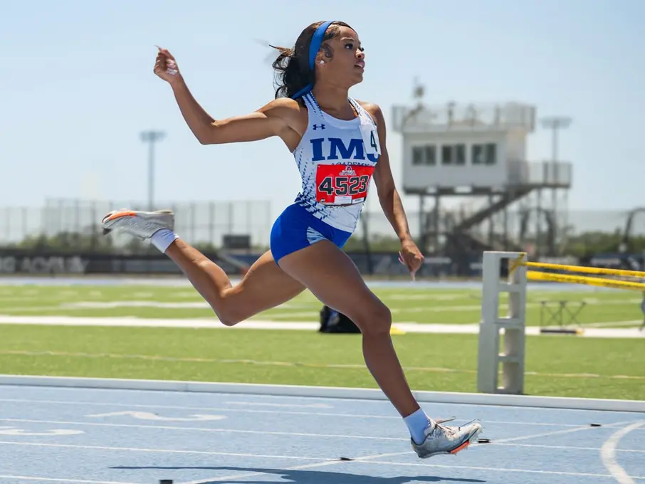 Athlete leaping toward the sand pit