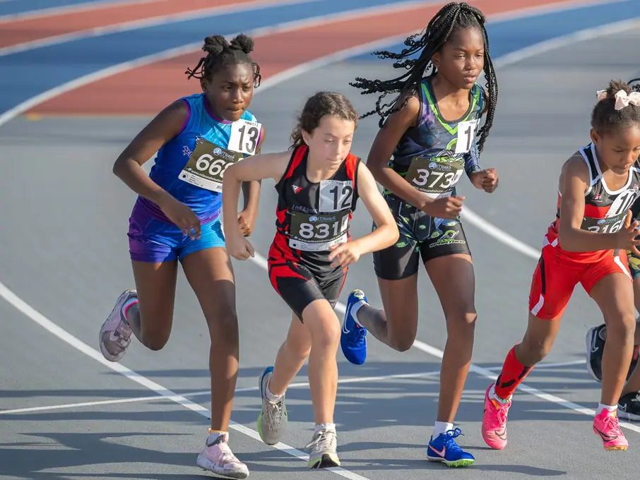 Young runner pushing through the finish
