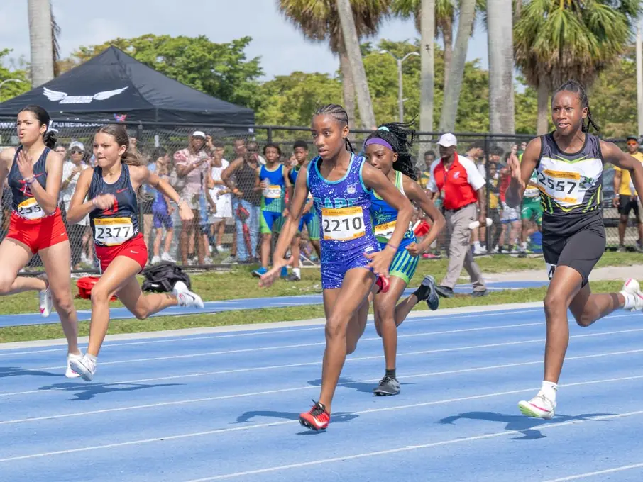Sprinters racing on a blue track