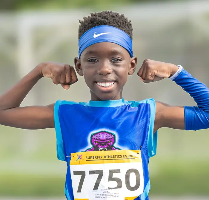 Superfly athlete in a blue headband flexing