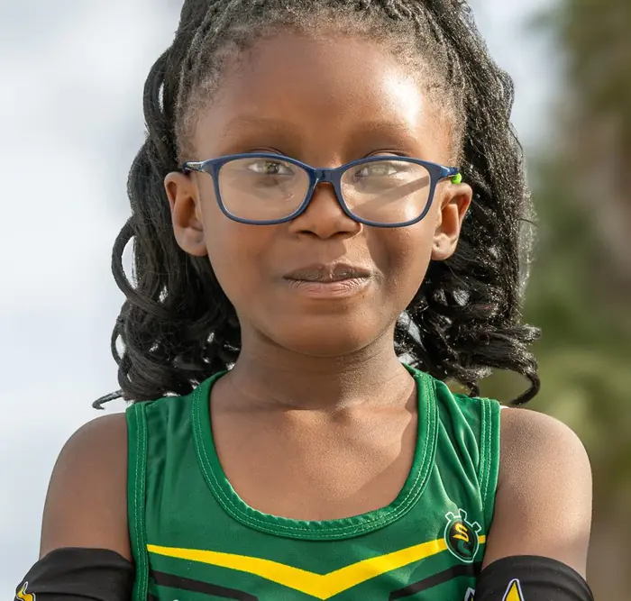 Young Delray athlete in glasses with arms crossed